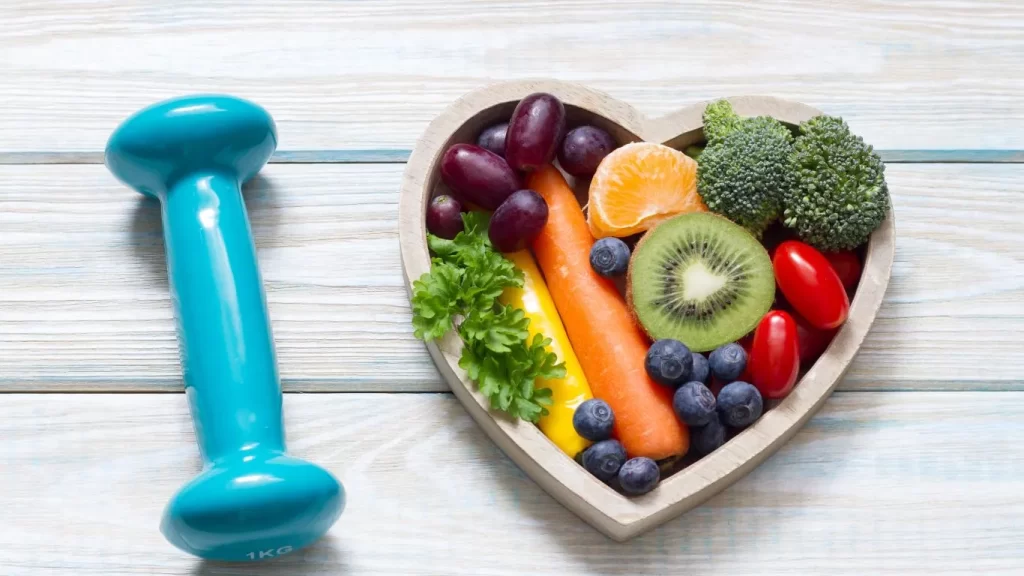 diet-fruits-in-heart-shaped-bowl-with-small-blue-Dumble